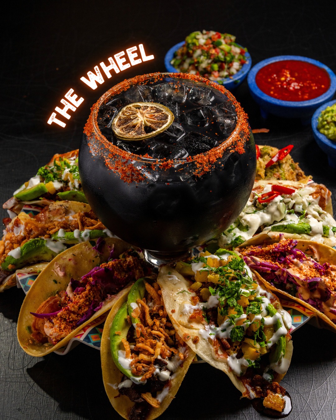 The Wheel — a tacos spread arranged around a chili-rimmed margarita goblet at Spitfire.
