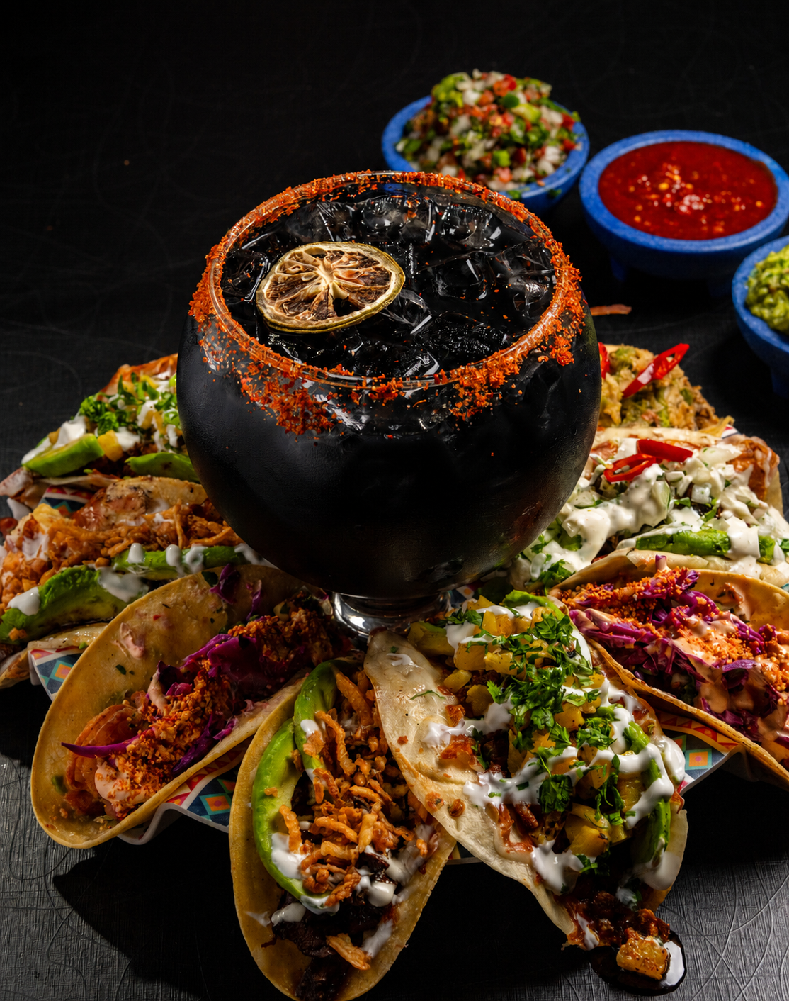 A tacos spread arranged around a chili-rimmed margarita goblet — drinks from Descanso and food from our partner kitchens.